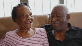 Senior couple kissing, a black Brazilian older husband and wife kiss, loving and caring relationship at old age - Powered by Shutterstock - Get 15% off with code: PIKWIZARD15