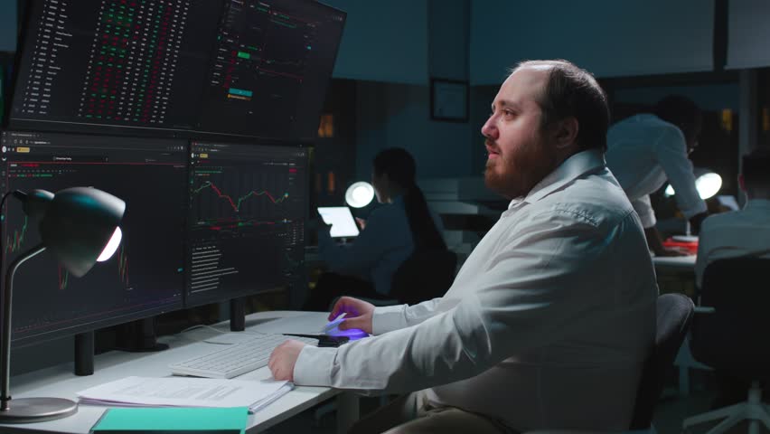 Side view of sad fat broker look at monitors and cry loosing investments money on stock market.  | Shutterstock HD Video #1105589117