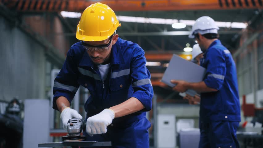 Worker man using grinding machine and cutting steel have spark from the grinding wheel at production factory industrial. Expert Man working hard in steel manufacturing plant Royalty-Free Stock Footage #1105591929