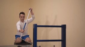 man trains in the gym. man doing exercises on the simulator. canoeing. High quality Full HD video recording 