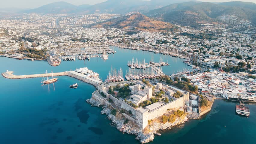 Bodrum ancient castle with Bodrum marina at sunrise, aerial view Royalty-Free Stock Footage #1105595013