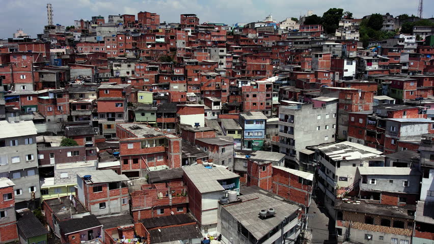 Drone shot over squatter homes, sunny day in Jaguare, Sao Paulo, Brazil, South America