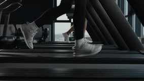 Sporty people jogging on treadmill unknown sportswoman female runner legs feet in sneakers run on sport machine in fitness gym cardio exercise jog fast interval running pace workout healthy lifestyle - Powered by Shutterstock - Get 15% off with code: PIKWIZARD15