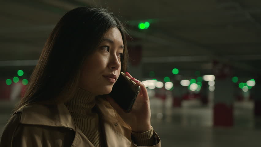 Worried upset Asian woman talk mobile phone in parking call worried talking disappointed smartphone conversation business problem chinese korean girl speak worry dissatisfied stressed trouble bad news Royalty-Free Stock Footage #1105603387