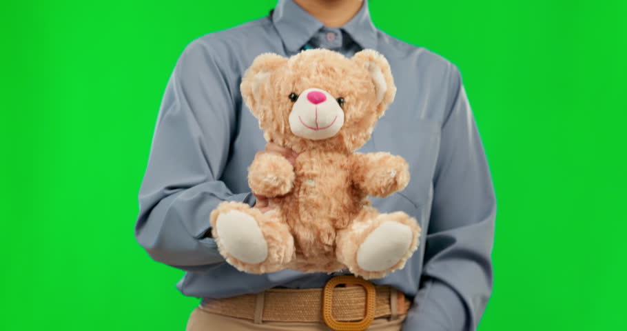 Teddy bear, green screen and person with charity gift for care, support and trust isolated in a studio background. Toy, soft and therapist giving a present or stuffed animal for comfort for a friend Royalty-Free Stock Footage #1105604857