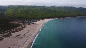 Sandy beach of a summer resort with a blue and clear sea, no people, footage taken from the air on a quadcopter