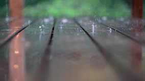 rain drops on wooden floor. slow motion detail. 4k video.