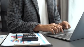 Businessman working on laptop and accounting financial report, accountant using calculator to calculate tax refund at office. - Powered by Shutterstock - Get 15% off with code: PIKWIZARD15