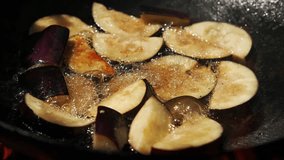 Close up video of frying eggplant in frying pan