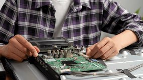 Close up of female LCD TV repair technician, professional factory worker. Television repair service concept