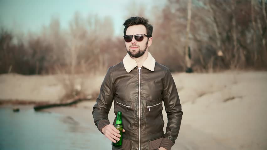 Weekend Chill Drinking Beer. Cool Refreshment At Serene Atmosphere. Pale Ale Beer Lover Chilled Beverages Tranquil Retreat. Sunset Sip Wheat Beer From Bottle. Calm Blissful Moment Sunset Reflection Royalty-Free Stock Footage #1105632355