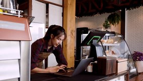 Portrait, shop owner bakery cafe working on laptop computers during day in the cafe, this is finding information about cafe add more, or find new menus add shop, make it more interesting unique. - Powered by Shutterstock - Get 15% off with code: PIKWIZARD15