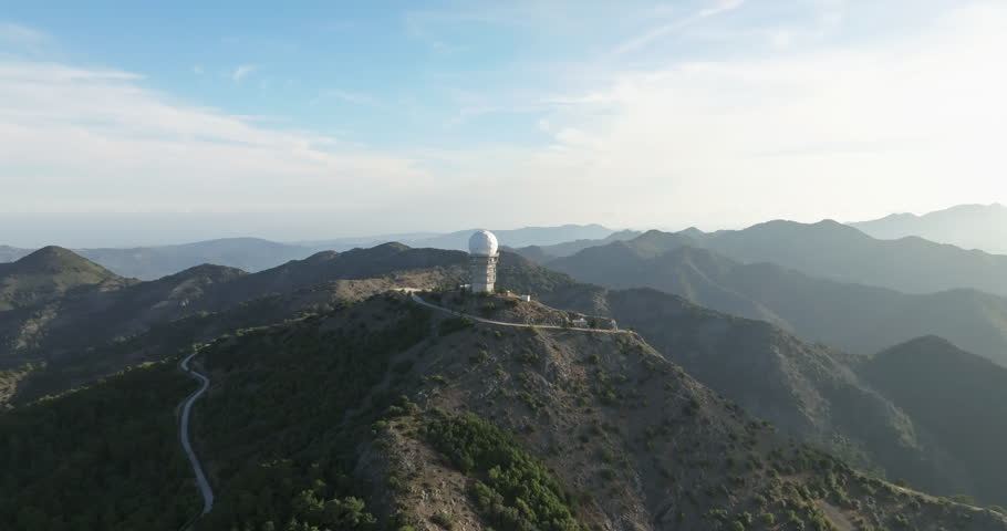 Aerial view of the observatory building in the mountains in a beautiful landscape. Science by astronomers and the study of stars by scientists using a telescope. High quality 4k footage