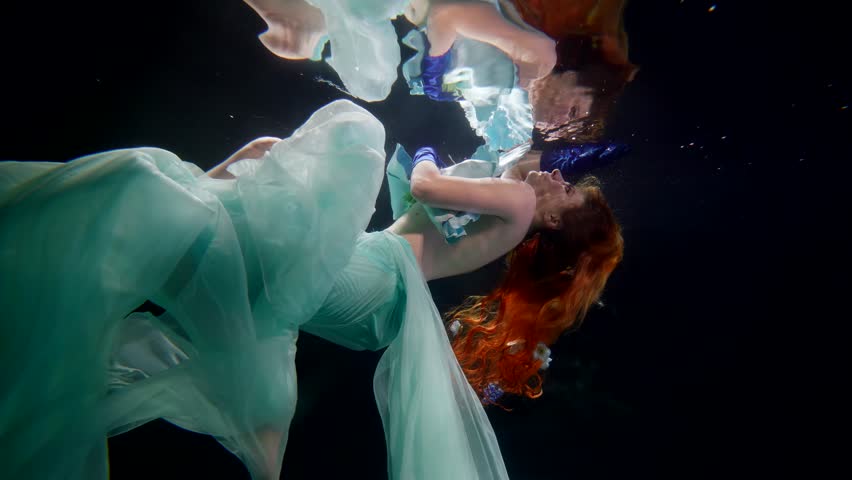 underwater fairytale, beautiful half-naked woman swimming alone under water surface