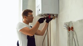 Professional engineer installing a natural gas boiler at home, he is checking the pipes - Powered by Shutterstock - Get 15% off with code: PIKWIZARD15