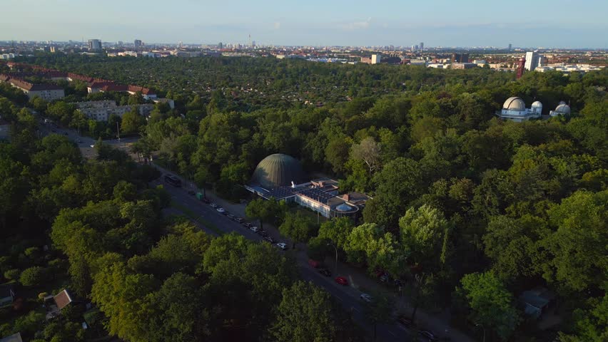 Lovely aerial top view flight Berlin city Planetarium Germany in Europe, summer day 2023. boom sliding to right drone
4K cinematic.