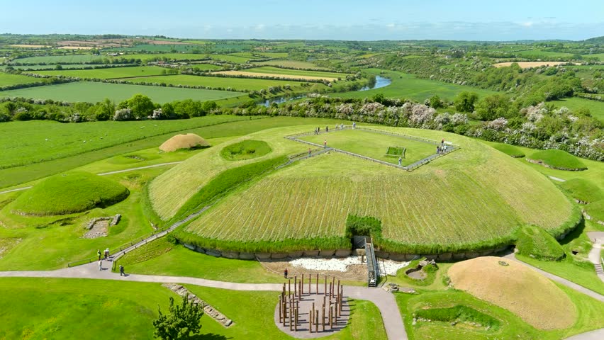 Aerial view of Knowth, the largest and most remarkable ancient monument in Ireland. Spectacular prehistoric passage tombs, part of the World Heritage Site of Bru na Boinne, valley of the River Boyne. Royalty-Free Stock Footage #1105647079