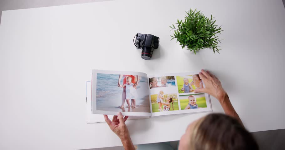 Woman Looking At Photo Album Or Photobook Royalty-Free Stock Footage #1105649501