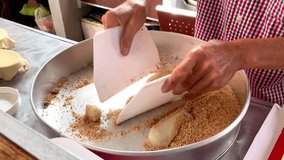 Finishing of Japanese Mochi cooking, covered with peanut crumbs, rolling and slicing on the flour.