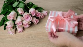 closeup female hands holding box with gift, bouquet of white, pink roses, box with gift with satin ribbon, flowers for professional holiday, concept of mother's, Valentine's day, birthday - Powered by Shutterstock - Get 15% off with code: PIKWIZARD15