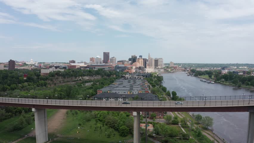 Super wide aerial dolly shot of Saint Paul, Minnesota with High Bridge spanning the Mississippi River in the foreground. 4K