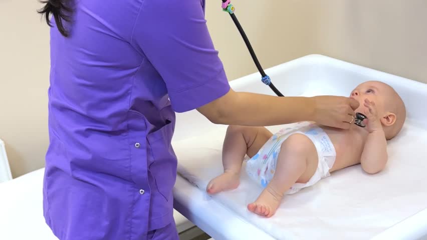 Happy adorable toddler patient examined by pediatrician on baby changing table. Kids doctor checking child with stethoscope in hospital office, examining heart beating and lungs at appointment Royalty-Free Stock Footage #1105674005