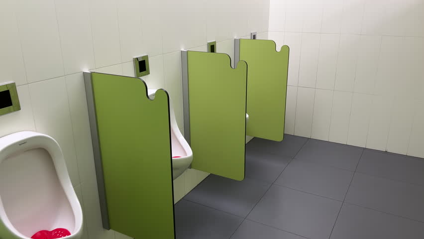 Rows of modern urinals with a sensor WC flush in a public men