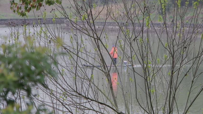 Wetland park watercourse workers boating to clean the water rubbish