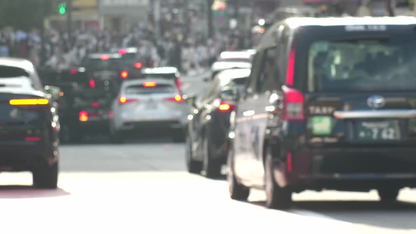 SHIBUYA, TOKYO, JAPAN : Blure View of street traffic around Shibuya crossing in busy rush hour. Shot in sunset time. Many cars and taxi at the road. Japanese transportation concept video. Royalty-Free Stock Footage #1105678993