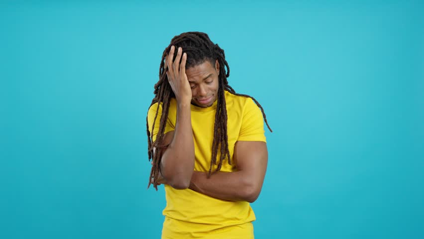 Bored latin man with dreadlocks standing and looking up Royalty-Free Stock Footage #1105683455