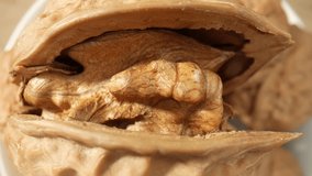 In this mesmerizing macro footage, witness the exquisite details of walnuts, as the camera zooms in on their rugged, brown husks and exposes the hidden treasure within. Grain and food concept. 4K
