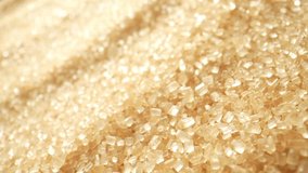 Macro video showcasing the texture and intricate details of brown sugar, captured with a probe lens. Delicate granules shimmer and cascade, revealing a rich golden hue and enticing caramel aroma. 
