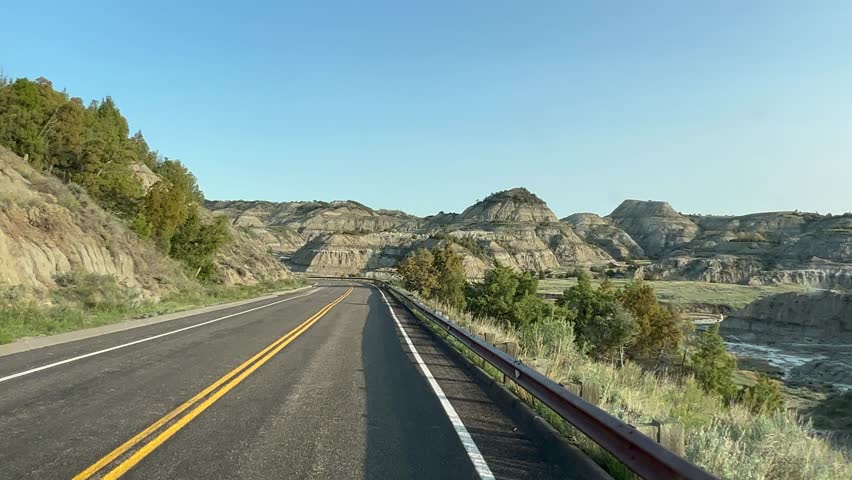Driving through the badlands hills and mountains in Theodore Roosevelt National Park in North Dakota.