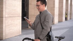 A young guy is using the phone calling talking to a friend. A man in a stylish gray oversize shirt. - Powered by Shutterstock - Get 15% off with code: PIKWIZARD15