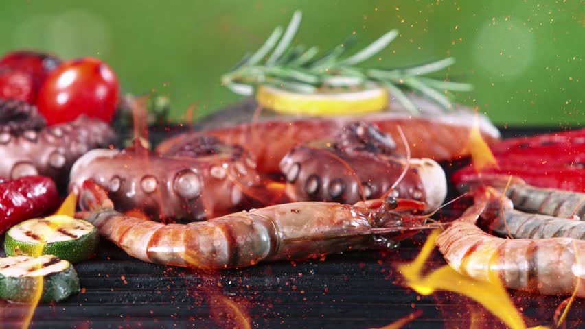 Super slow motion of mix of sea food, fish and vegetable on grill grid. Filmed on high speed camera, 1000 fps