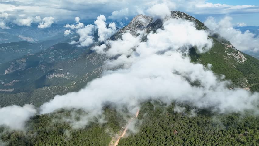 Heavenly Horizons: Aerial View of the Enchanting Mountain Panorama, Clouds, and Lush Green Forests