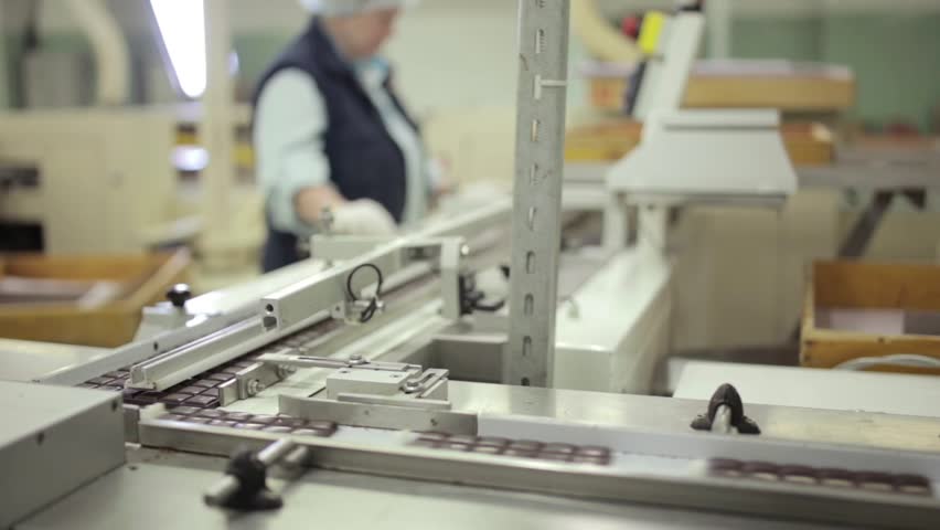 static medium shot of conveyor line with classic chocolate bars in a chocolate factory