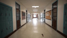 Wide angle push in down a long empty high school corridor hallway lined with student lockers. - Powered by Shutterstock - Get 15% off with code: PIKWIZARD15