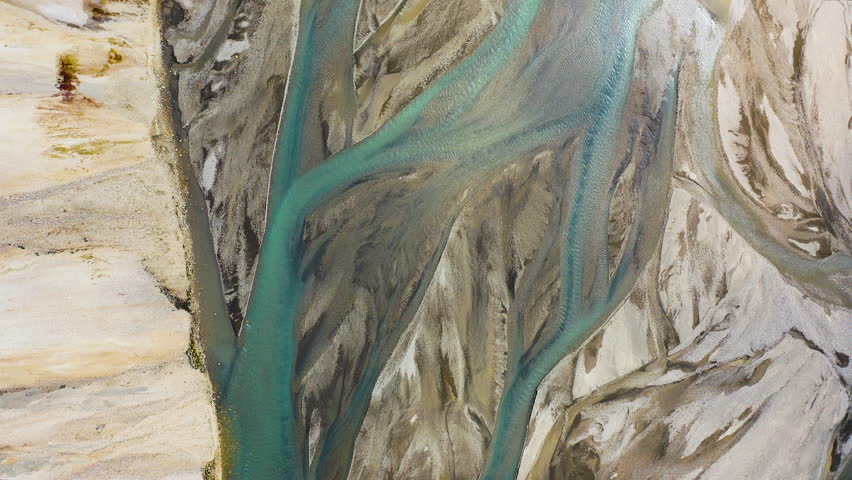 Aerial view of snowmelt producing torrents of frozen water in the Landmannalaugar valleys, Iceland.