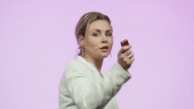 Portrait of Caucasian woman female speaker presenting on the stage during conference. Presenting ideas against bright pink background - Powered by Shutterstock - Get 15% off with code: PIKWIZARD15