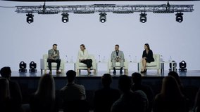 Group of 4 experts sitting on stage, answering audience questions during the conference. Neutral white bacgkround - Powered by Shutterstock - Get 15% off with code: PIKWIZARD15