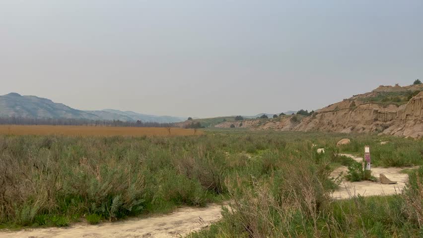 Panning Left on the badlands hills and mountains in the Cannonballs area in the North Unit in  Theodore Roosevelt National Park in North Dakota.