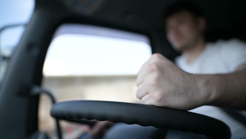 Truck driver hitting the steering wheel angrily Royalty-Free Stock Footage #1105710277