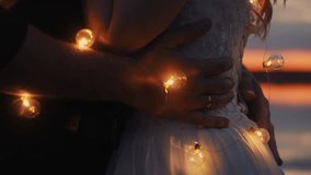 Tender Embrace Of Bride And Groom In Darkness On Beach Of Lake, First Dance Of Newlyweds, Closeup - Powered by Shutterstock - Get 15% off with code: PIKWIZARD15