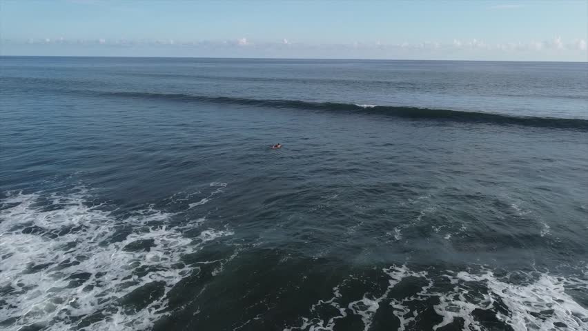 Aerial drone view. Waves in the ocean. Man are swimming in waves. 