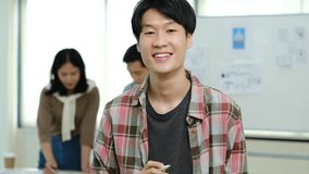 Tilt down shot of asian male web developer holding digital tablet and smiling to camera - Powered by Shutterstock - Get 15% off with code: PIKWIZARD15