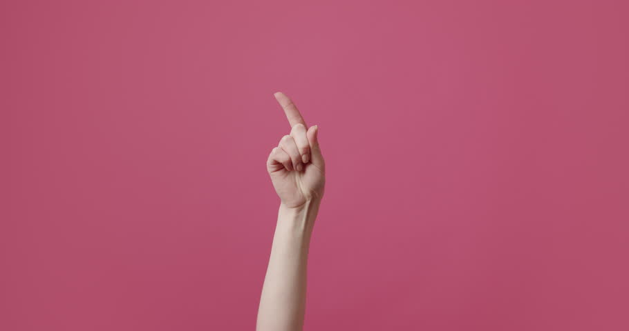 A woman's hand gesticulates, shows a sign that it is not possible, wags its finger in different parts. Access forbidden. Shaking finger saying no. Finger signal. Disapproving gesture. Negation gesture