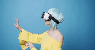 An young woman is using innovative technology vr glasses for play games and relax herself, using 360 VR headset glasses of virtual reality. Concept of future, innovation, technology, gaming,lifestyle.
