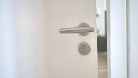Female hand closing white wooden door, business, hotel, house, condominium, apartment, resident, holding door handle, travel concept, tourist, selling, buying, rental, Full HD video motion