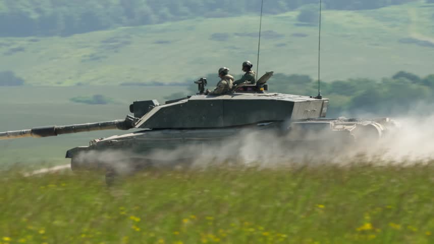 close-up of a commander and gunner directing a british army Challenger 2 ii FV4034 main battle tank in action on a military battle exercise, Wiltshire UK   